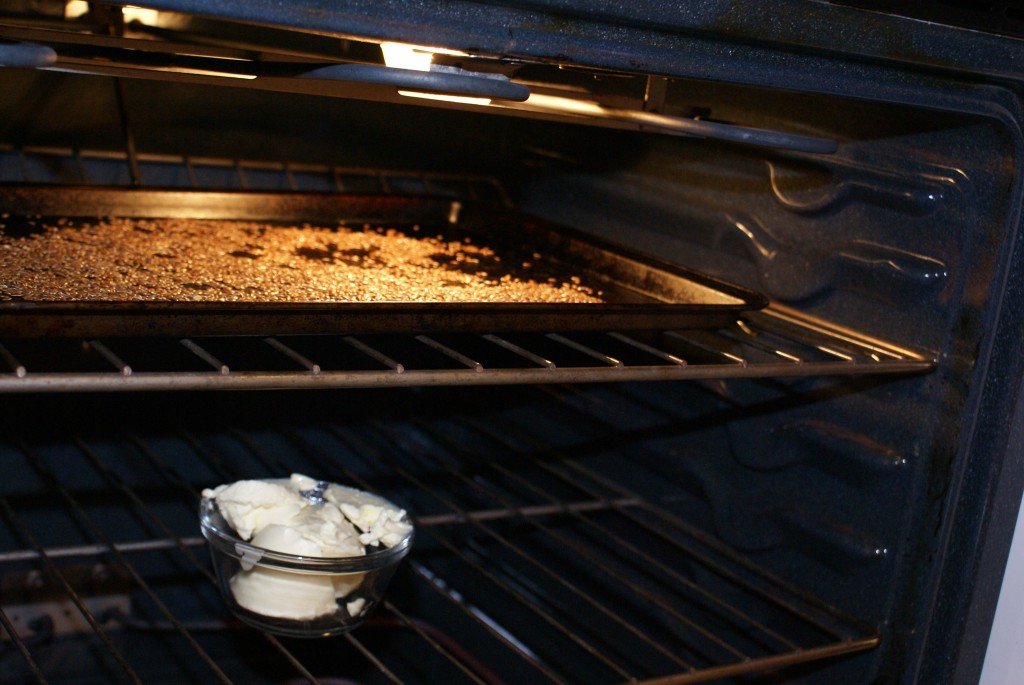 Roasting flax seeds and softening margarine while preheating oven.