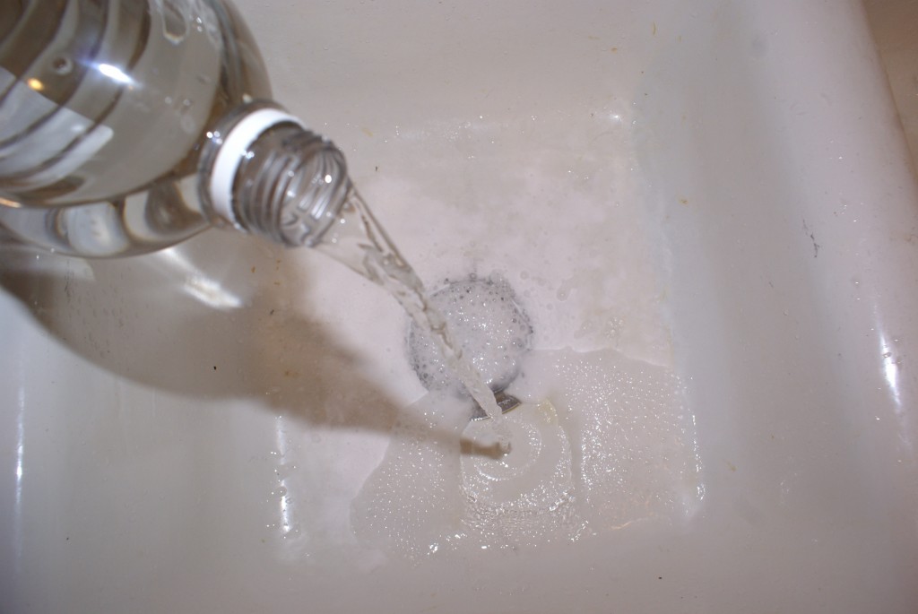 Vinegar and baking soda bubbling in sink.