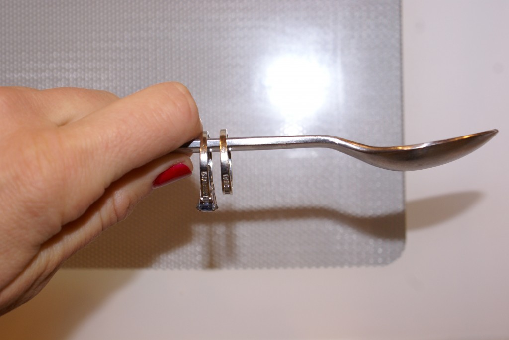 Clean wedding rings with steam by first placing them on a spoon or other such utensil.