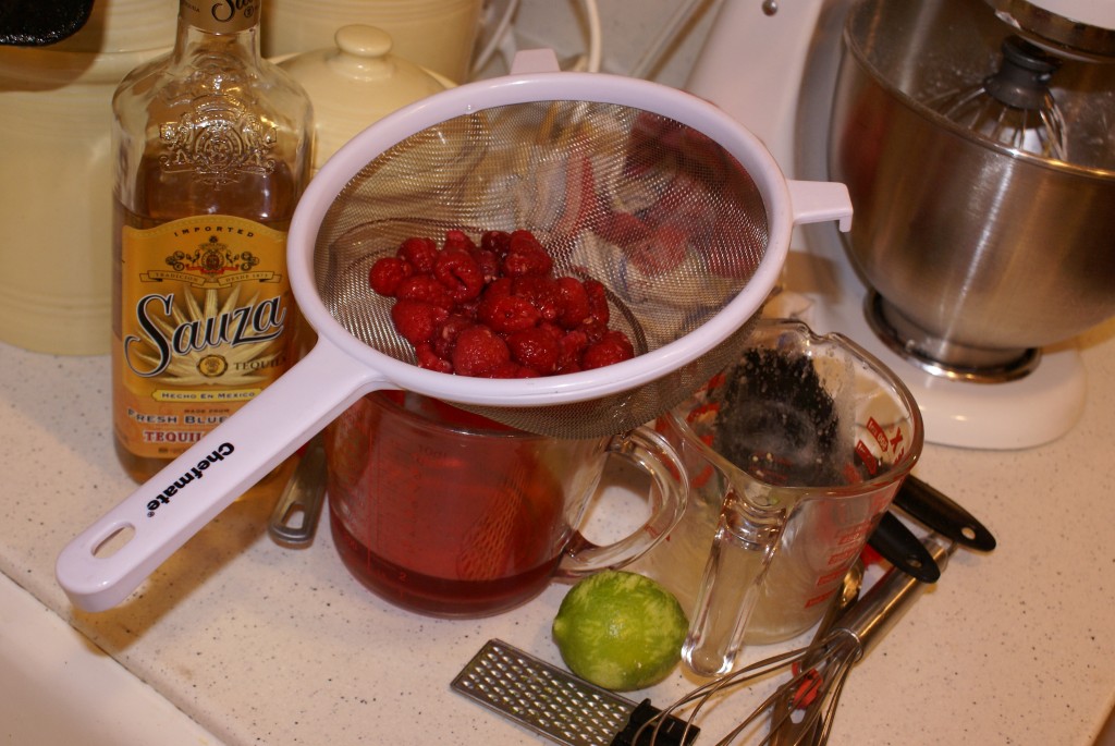 Raspberries soaked in tequila. Draining the tequila-soaked raspberries.