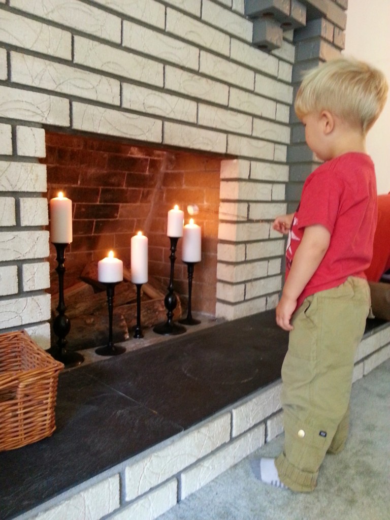 After spending all Summer road tripping and camping, Arlo was very excited to roast marshmallows in our fireplace : )  Notice the water marks and dingy looking slate.  It's all brightened up now with just a few coats of clear spray paint!