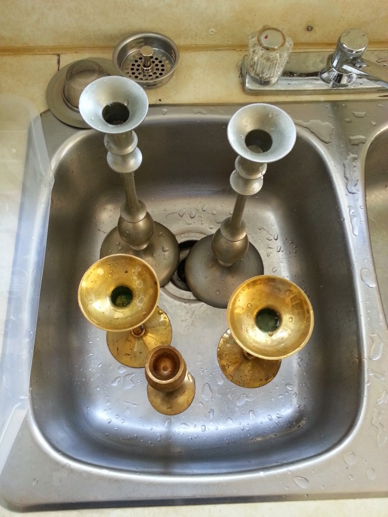 Thrifted candlesticks.  Two sets of matching candlesticks and one odd man out getting a good scrub in the sink.