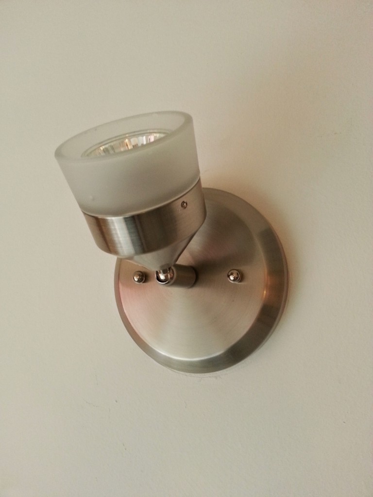 Small wall sconce installed upside down actually gives off a lot of light.
